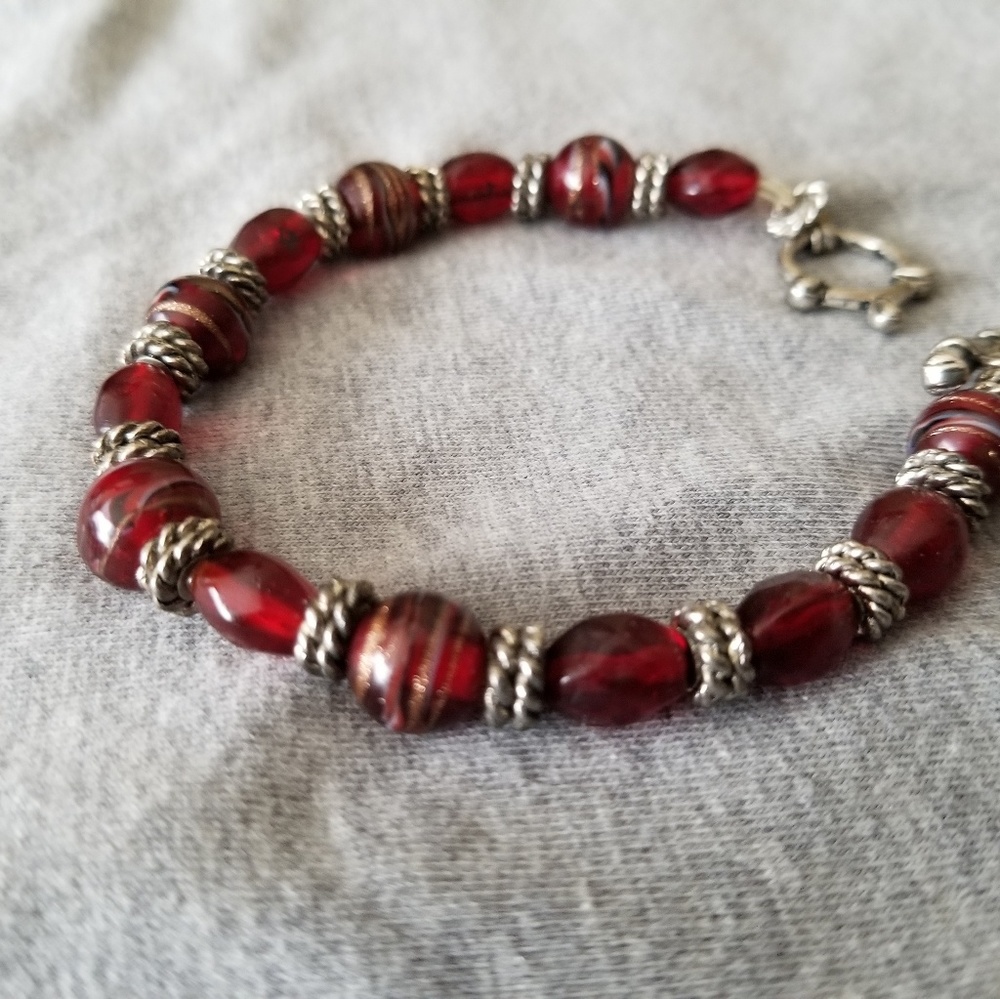 Red beaded bracelet with silver accents